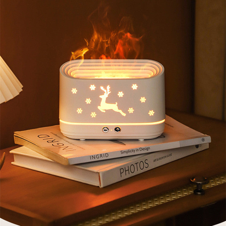 White decorative humidifier with lighted reindeer and snowflakes on books on wooden nightstand