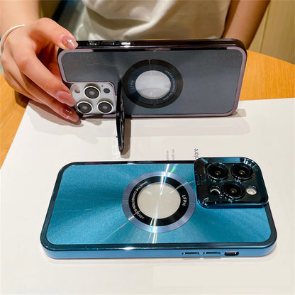 Two iPhones with shiny blue and gray protective cases featuring large circular metal rings and triple camera setups on a wooden table
