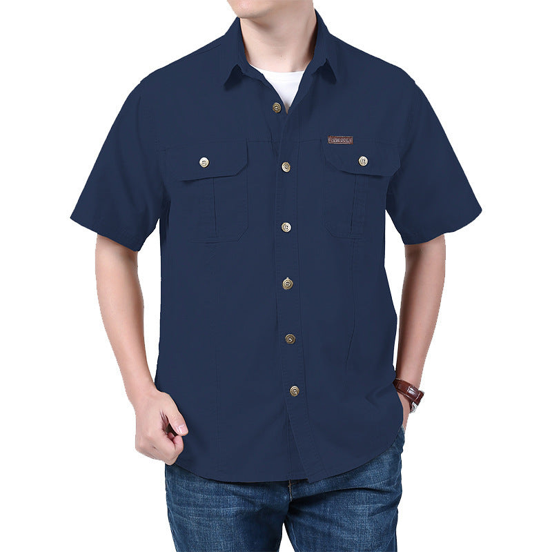 Man wearing navy blue short-sleeve button-up shirt with two chest pockets and brown buttons