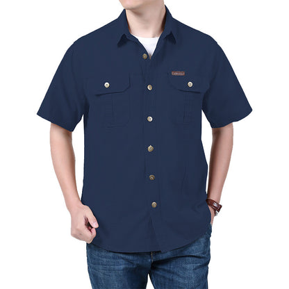 Man wearing navy blue short-sleeve button-up shirt with two chest pockets and brown buttons