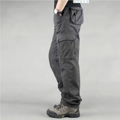 Side view of person wearing black cargo pants with multiple pockets and gray hiking boots