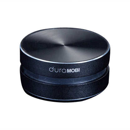 Black round duraMOBI Bluetooth speaker with metallic top on white background