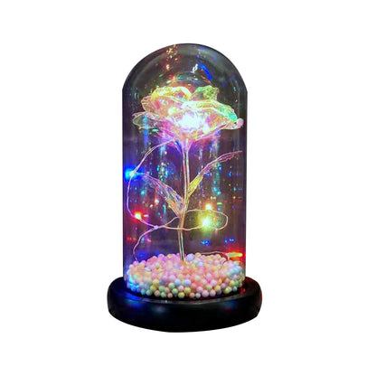 LED lighted glass dome with glowing crystal rose and multicolored beads on black base