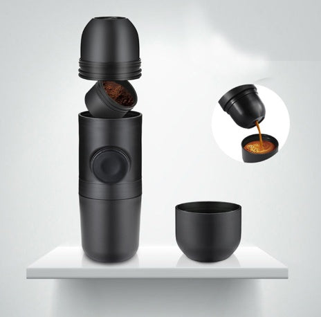 Black portable coffee maker with detachable grinding and brewing components on white surface