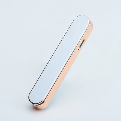 Portable sleek white and rose gold electronic device with USB charging port on side