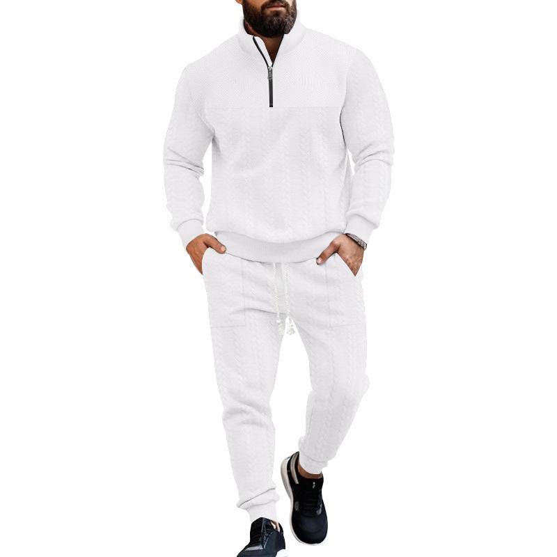 Man wearing white cable knit quarter-zip sweater and matching jogger pants with black sneakers