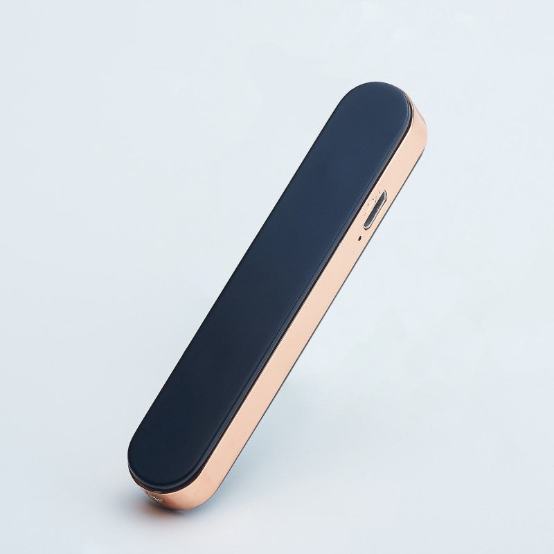 Sleek black and rose gold portable electronic device with USB port on white background