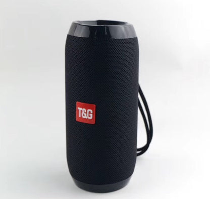 Black portable T&G Bluetooth speaker with mesh body and wrist strap on white background