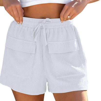 White textured cargo shorts with elastic waistband and drawstring worn by woman