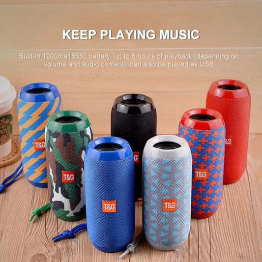 Colorful T&G portable Bluetooth speakers with fabric cover and wrist strap on wooden surface