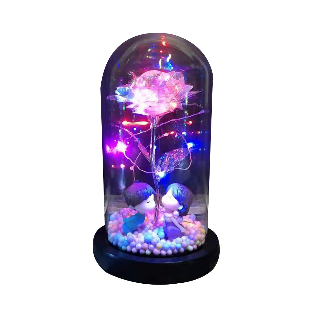 Romantic LED light dome with a glowing rose and two kissing figurines on colorful beads