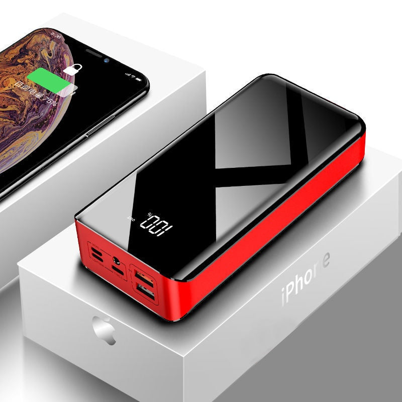 Portable black and red power bank with digital display on iPhone packaging box and iPhone connected