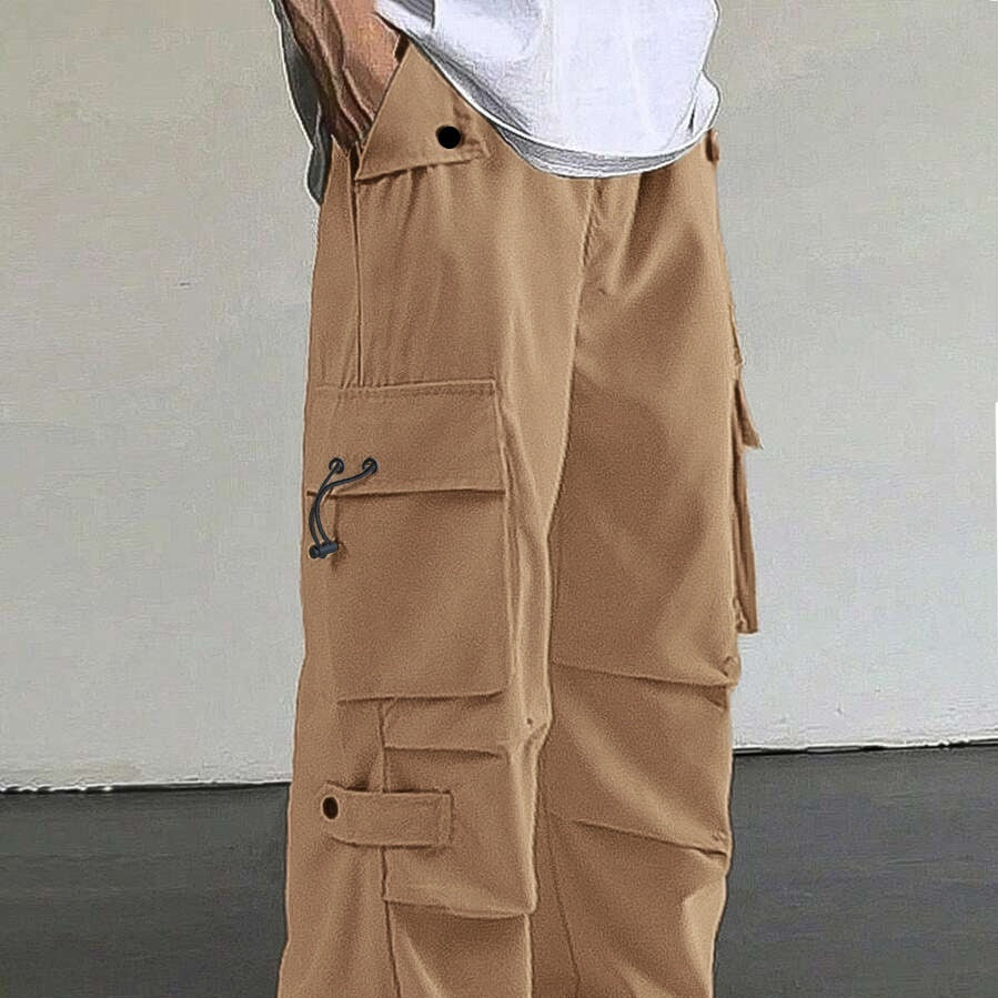 Beige cargo pants with multiple pockets and black adjustable drawstring details worn with a white shirt