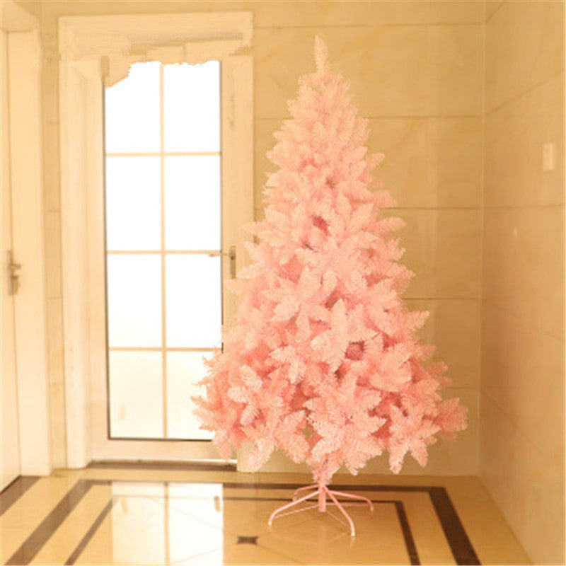 Artificial pink Christmas tree in minimalistic room with beige tiled walls and glass door