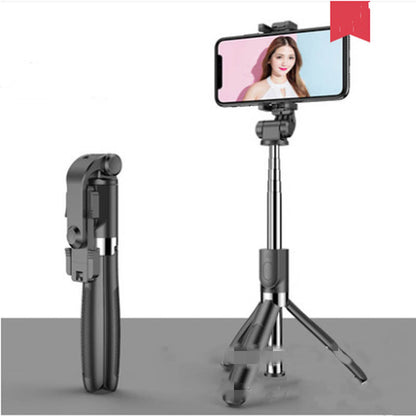 Black foldable selfie stick tripod with smartphone holder and phone displaying woman's portrait