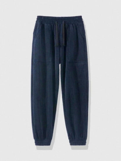 navy blue corduroy jogger pants with elastic waistband and cuffed ankles