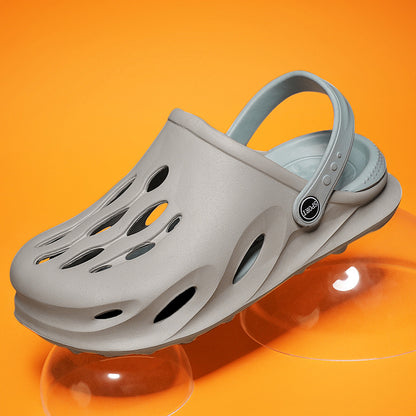Gray sporty clog with ventilation holes and a back strap on an orange background