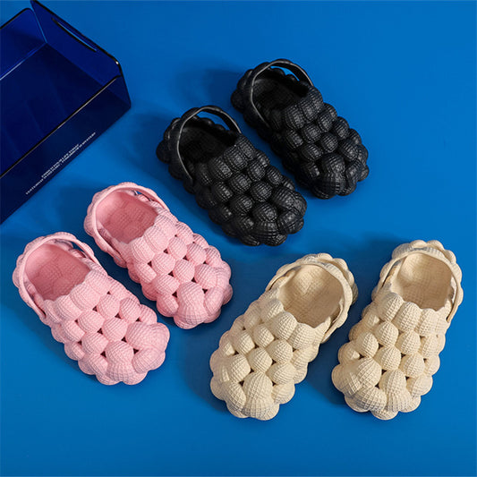 Three pairs of textured bubble design slip-on shoes in black, pink, and beige on blue background