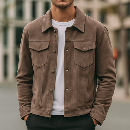 Man wearing brown suede jacket over white t-shirt in urban outdoor setting