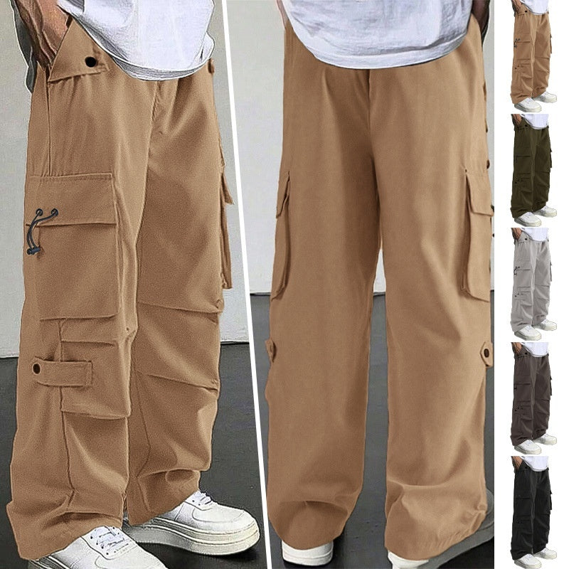 Beige cargo pants with multiple pockets and strap details, worn with white sneakers