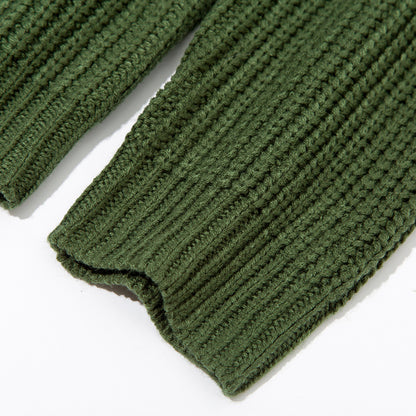 Close-up of green knitted sweater sleeves with ribbed cuffs on white background