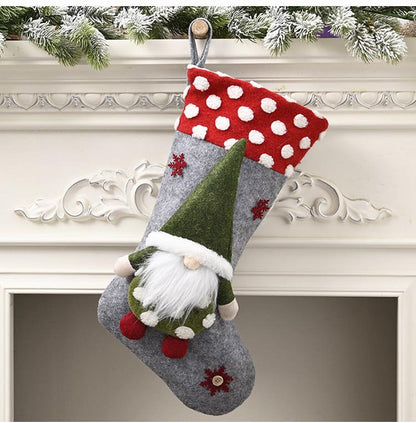 Christmas stocking with red polka dot cuff and gnome decoration hanging on white mantel