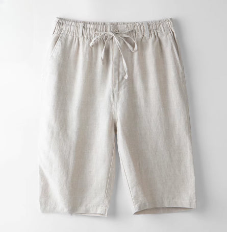 Light beige casual linen shorts with elastic waistband and drawstring tie on white background