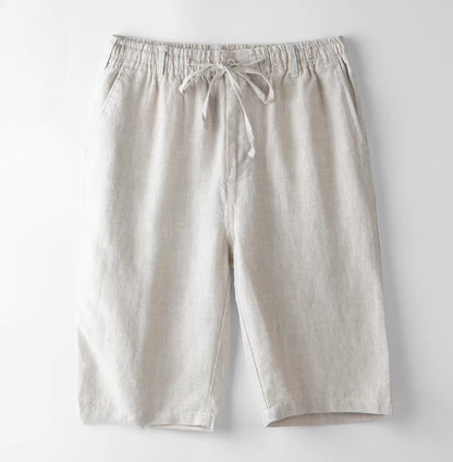 Light beige casual linen shorts with elastic waistband and drawstring tie on white background