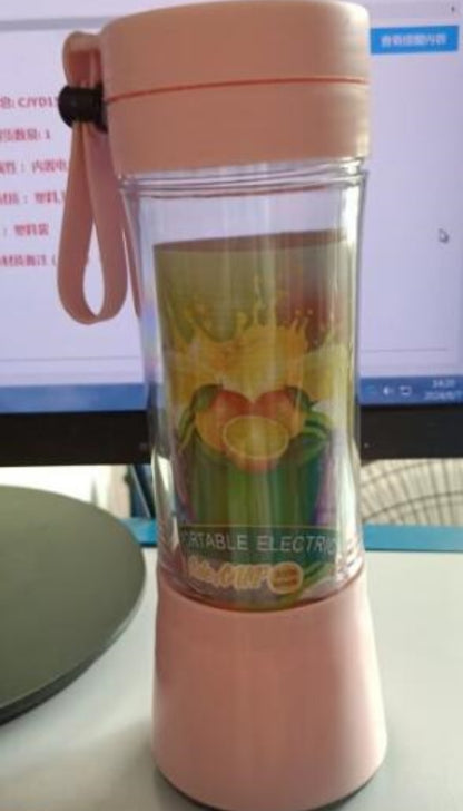 Pink portable electric blender with fruit graphics on transparent container and wrist strap