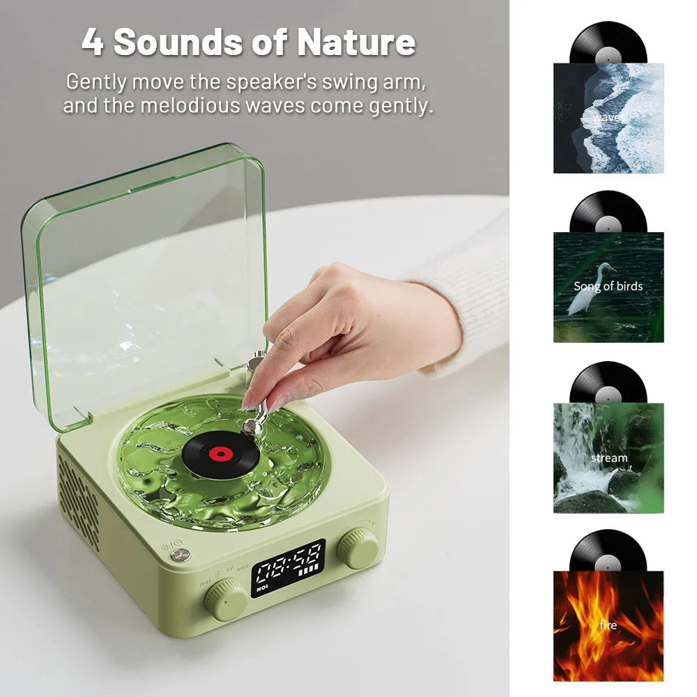 Hand adjusting green nature sound speaker with vinyl record and 4 sounds: waves, birds, stream, fire