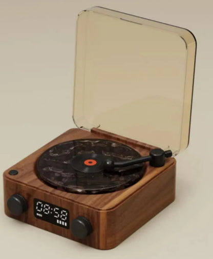 Compact wooden turntable with digital clock, marble-patterned vinyl, and transparent dust cover
