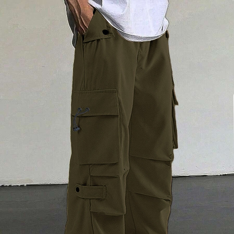 Close-up of olive green cargo pants with multiple pockets and black button details