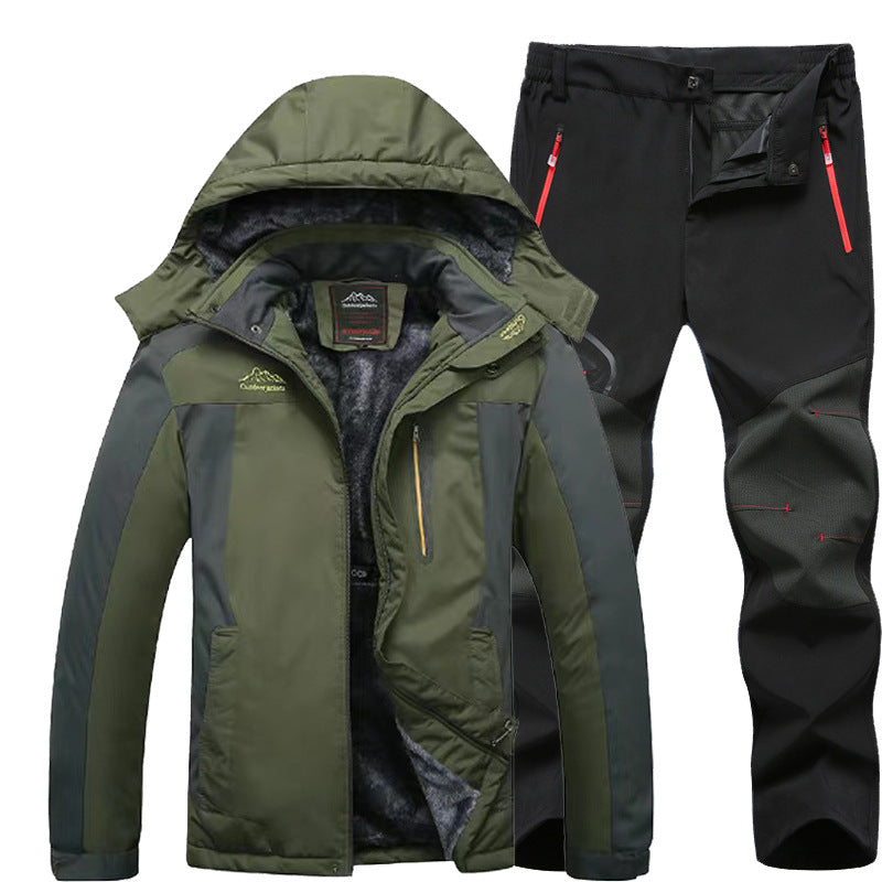Men's green and gray insulated winter jacket with hood paired with black outdoor pants with red zipper pockets