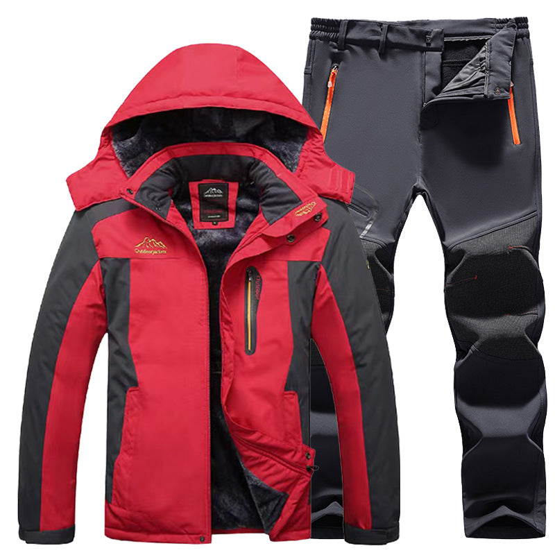 Red and black waterproof winter jacket with hood and black insulated pants with orange zipper pockets