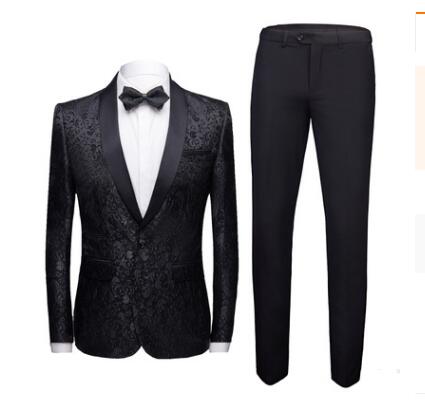 Men's black floral jacquard tuxedo jacket with satin lapels and matching black dress pants, white shirt, and bow tie