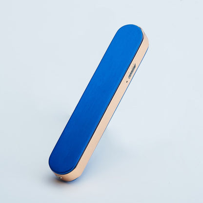 Blue and rose gold sleek portable electronic device on light background