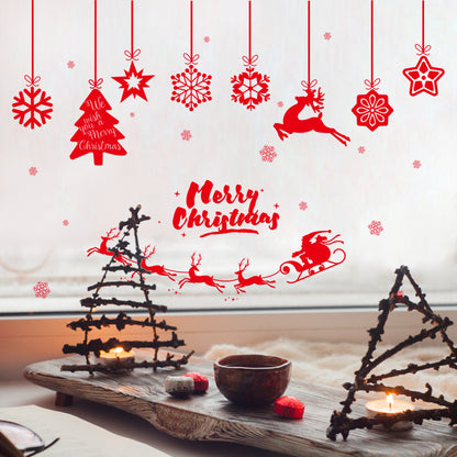 Cozy Christmas scene with twig tree candles, hot drink, and red festive window decals