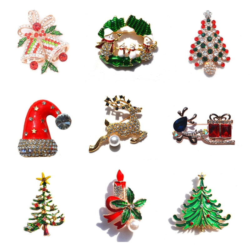 Set of nine festive Christmas brooches including bells, snowmen, trees, Santa hat, reindeer, candle, and sleigh gifts