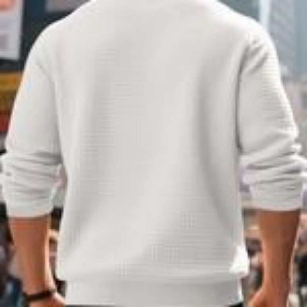 Back view of man wearing white casual sweatshirt with rolled-up sleeves in urban setting