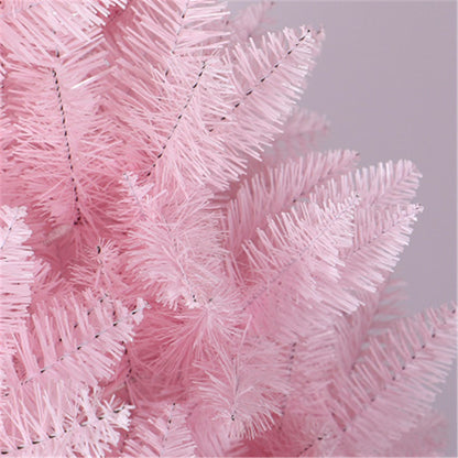 Close-up of pink artificial Christmas tree branches with soft needles on light gray background