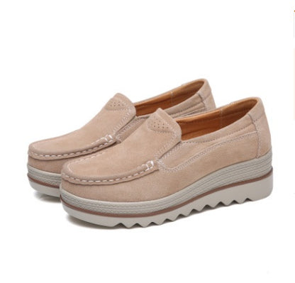 Beige suede slip-on platform loafers with white stitching and wavy rubber soles