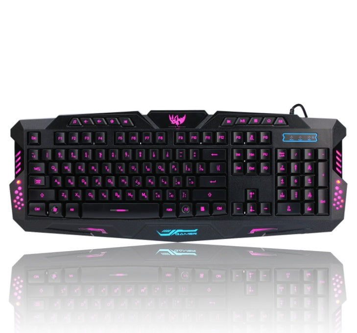Black wired gaming keyboard with pink backlit keys and gaming logo on top center
