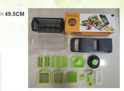 Kitchen veggie slicer set with multiple green blades, black container, transparent box, and peeler on beige surface