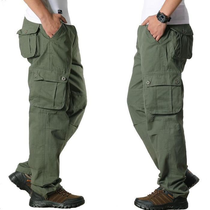 Side view of men wearing olive green cargo pants with multiple pockets and brown hiking shoes