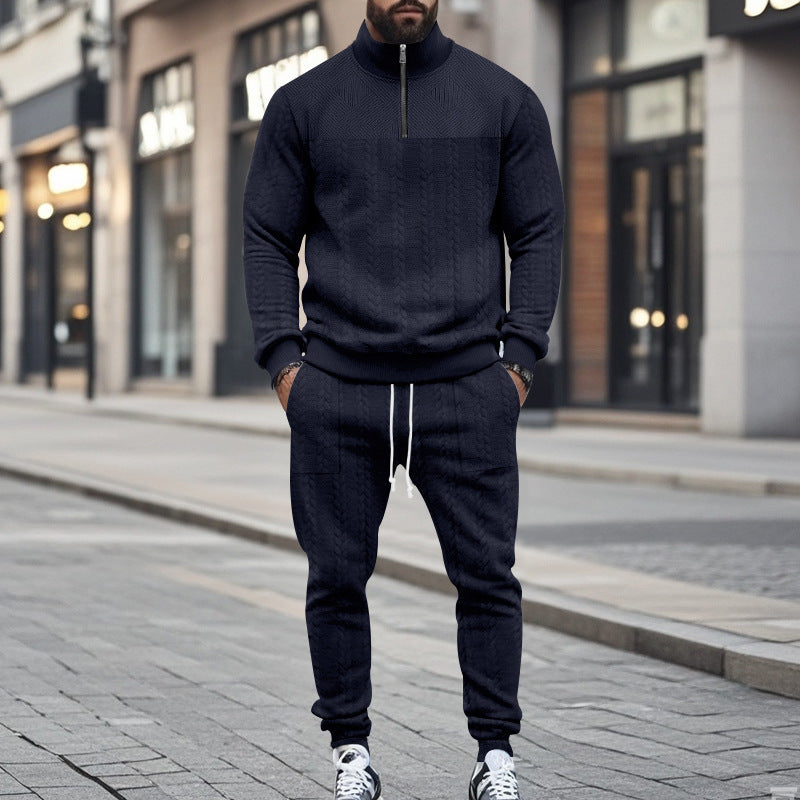 Man wearing navy blue cable knit zip-up sweater and matching jogger pants on city street
