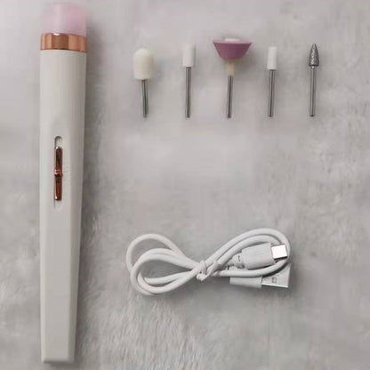 White electric nail drill with five silver tool bits and a white USB charging cable on a soft surface