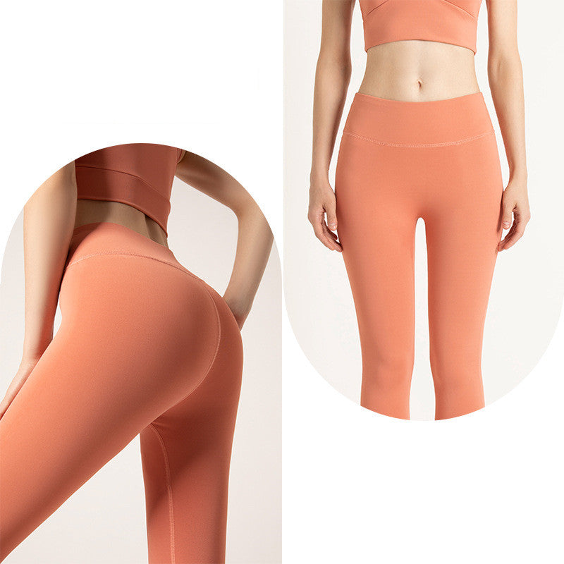 Woman wearing high-waisted coral orange seamless leggings and matching crop top, front and back views