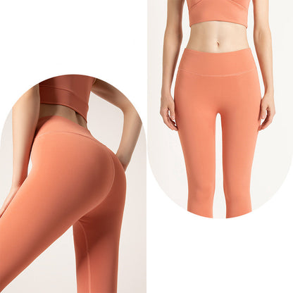 Woman wearing high-waisted coral orange seamless leggings and matching crop top, front and back views