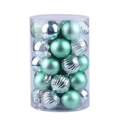Clear cylindrical container with shiny green and silver Christmas tree ornaments
