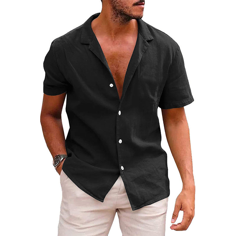 Man wearing black short-sleeve button-up shirt and light beige pants, casual summer outfit